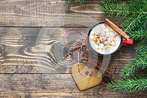 Christmas hot chocolate with marshmallows, cookies and cinnamon on the wooden background. Top view and copy space.