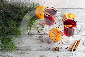 christmas hot mulled wine with cinnamon orange and anise on white wooden background