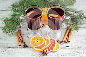 christmas hot mulled wine with cinnamon orange and anise on white wooden background