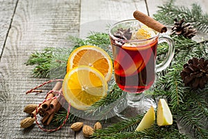 Christmas hot mulled wine with cinnamon, orange and christmas tree on board. Winter tradition drink.