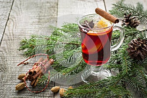 Christmas hot mulled wine with cinnamon, orange and christmas tree on board. Winter tradition drink.