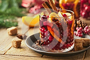 Christmas hot mulled wine. Glasses of mulled wine with aromatic spices cinnamon, anise, sugar and fir tree branches with bokeh and