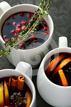 Christmas hot mulled wine or gluhwein drink in a cups with orange citrus,apple,cinnamon sticks and stars anise