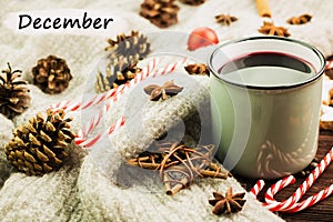 Christmas hot steaming cup of glint wine with spices, cinnamon, anise, cookies in a shape of star, red candies, fir cones, pepper