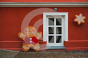 Christmas house window with gingerbread man decoration, festive background