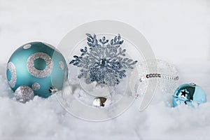 Christmas image of blue and white ornaments on white background.