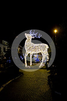 Christmas installation in the shape of a reindeer, blurred with sharp and film grain effect to make the photo look antiqued