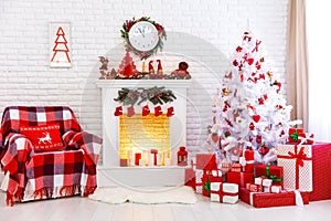 Christmas interior in red and white colors with tree and fireplace.
