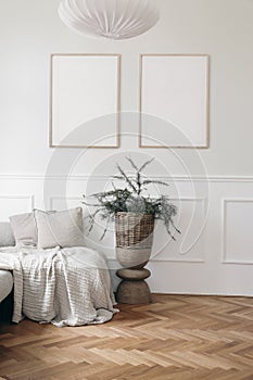 Christmas interior. Two blank vertical wooden picture frames mockups. White wall background.. Bed, sofa with linen