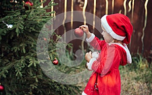 Christmas in july. Child waiting for Christmas in wood in july