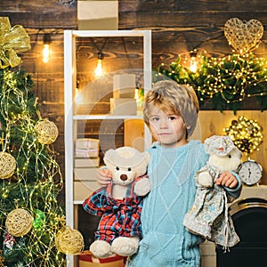 Christmas kids - happiness concept. Home Christmas atmosphere for child. Happy little child dressed in winter clothing