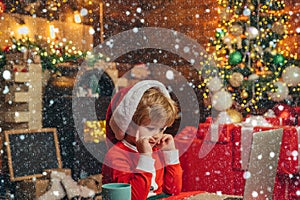 Christmas kids in snow. Buy christmas gifts online. Christmas shopping concept. Gifts service. Santa little helper