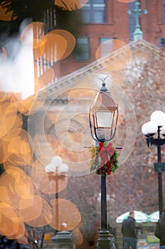 Christmas lamppost seen through holiday lights, Washington Square Park NYC