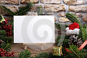 Christmas landscape card mockup template with fir twigs and Christmas decoration on wooden background