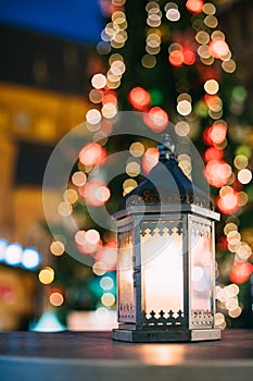 Christmas Lantern With Burning Candle On Bright Blurred Christmas