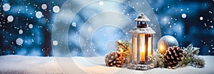 Christmas lantern with burning candle, pine cones and fir branches on snow, panoramic banner