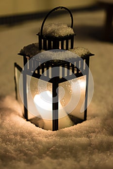 Christmas Lantern with burning candle on Snow Evening Scene