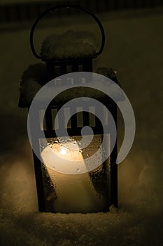 Christmas Lantern with burning candle on Snow Evening Scene