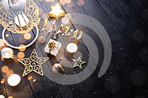 Christmas lantern with candle and decorations on a dark wooden table