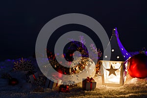 Christmas lantern and decor in snow