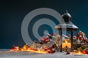 Christmas lantern and decor in snow