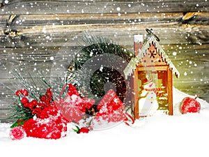 Christmas lantern decoration winter berries and snow on wooden b