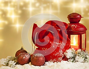 Christmas lantern gifts and baubles on snow