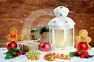 Christmas lantern with gifts, colored balls on a winter wood backgroun