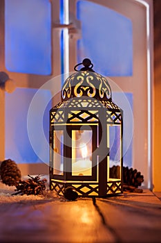 Christmas lantern with glowing candle