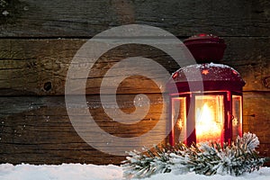 Christmas lantern light in night on snow