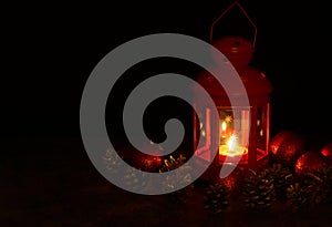 Christmas lantern, pine cones and toys at night  background.