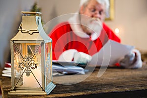 Christmas lantern and Santa Claus in background