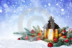 Christmas Lantern On Snow With Fir Branch and Baubles. Winter Decoration Background