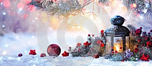 Christmas Lantern On Snow With Fir Branch in the Sunlight photo