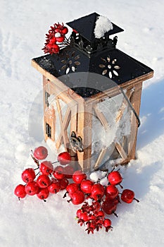 Christmas lantern on snowy background.