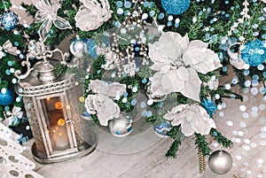 Christmas Lantern under Christmas tree with decoration, snow, blurred, sparking, glowing
