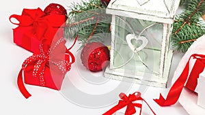 Christmas lantern on a white background with a fir branch, red balls, decorations. Winter background new year concept