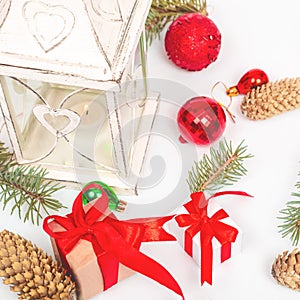 Christmas lantern on a white background with a fir branch, red balls, decorations. Winter background new year concept