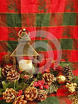 Christmas lantern, white candle, pine cones, red berries, poinsetta flowers,