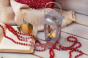 Christmas Lanterns, mandarin , red beads on wooden background.