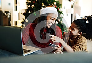 Christmas, laptop and credit card with mother and girl for online shopping, gift or digital payment. Fintech, ecommerce