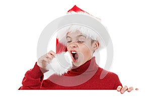 Christmas laughing boy in Santa hats is showing