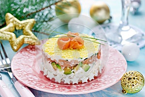 Christmas layered salad with salmon, avocado, rice and cream cheese salad
