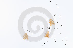 Christmas layout. Golden star shaped confetti and homemade ginger cookies on a white background. New Year 2019, christmas, winter