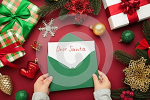 Christmas letter from a child to Santa Claus with the words: Dear Santa. Christmas composition with yellow and green toys