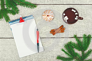Christmas letter. Cup of hot coffee with cinnamon and marshmallow, tangerine, fir branches and pine cone.