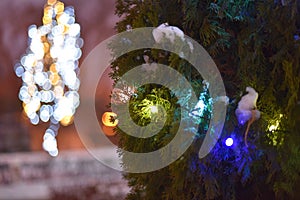 Christmas light background. Decorated with garland trees . Holiday glowing backdrop during the night. Defocused