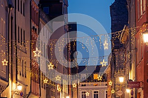 Christmas light chain decoration in the WahlenstraÃŸe in the old town of Regensburg during night