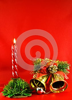 Christmas lighting candle and golden jingle bells