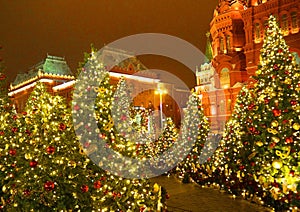 Christmas lighting and decorated Christmas trees on Manezhnaya Square in the center of the city on background of Kremlin in Moscow